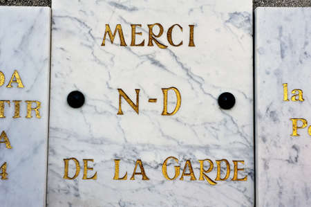 votive offerings or thanksgiving to Our Lady of the Guard of Marseille materialized by a marble plaque for a wish come trueのeditorial素材