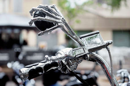 Detail of a mirror in the shape of a hand skeleton shopper to a gathering of American motorcycles in Beaucaire in the French department of Gardのeditorial素材