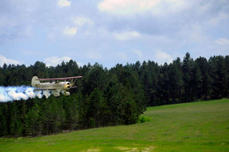 Biplane taking off, releasing smoke from the Mende airfield in the French department of Gardのeditorial素材