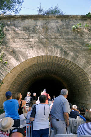 entry of a cruise ship into a tunnel du canal du midi near Beziersのeditorial素材