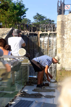Passage of a lock to Fonserannes on the Canal du Midi near beziers by a cruise shipのeditorial素材