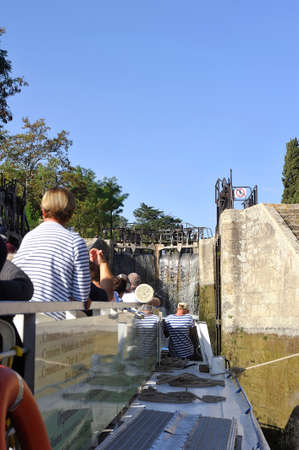 Passage of a lock to Fonserannes on the Canal du Midi near beziers by a cruise shipのeditorial素材