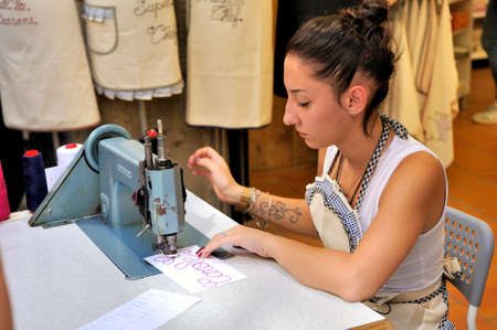 Young embroiderer realize custom embroideries in the center of the city of Carcassonne
