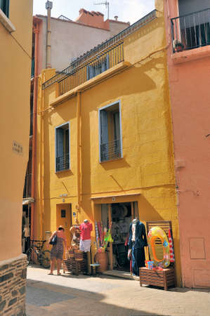 A small street in Collioure with colorful houses and souvenir shopsのeditorial素材