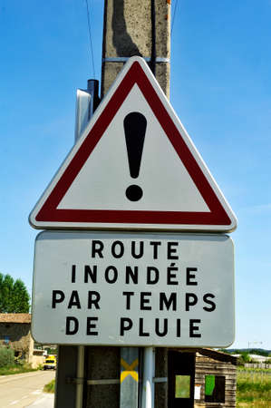 road sign indicating flood hazard in rainy weatherのeditorial素材