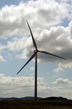 wind turbines in a countryside landscape on a background of cloudy sky