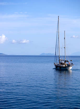 Sailing boat cruising on tranquil Ionian seas in Greece のeditorial素材
