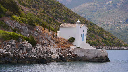 Whitewashed church at the mouth of the port of Vathi on the Island of Ithaca in Greeceのeditorial素材