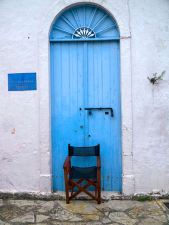 Blue door with a sunburst window above in the village of Fiskardo on the Island of Kefalonia in Greeceのeditorial素材