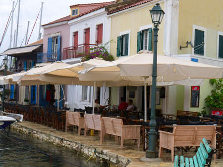 Pretty cafe\'s on the waters edge in the bay of Fiskardo on the Island of Kefalonia in Greeceのeditorial素材