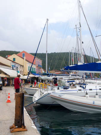 Yachts moored in the harbour of Fiskardo on the Island of Kefalonia in Greeceのeditorial素材