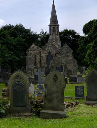 Spooky gravestones in the grounds of a church yard.のeditorial素材