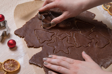 Cutting Christmas cookies, baking gingerbread men, making christmas cookie , homemade traditional ...