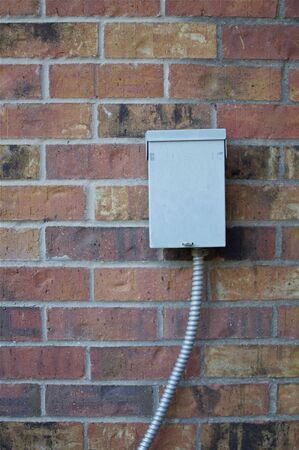 Metal Box on Brick Wall Backgroundの写真素材