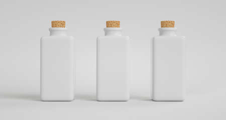 Three square porcelain pots with a cork stopper. Light backgroundの写真素材