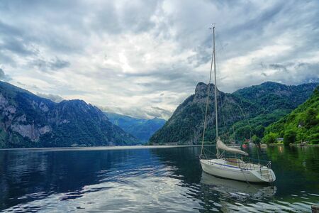 Lake in Austria with a boat between mountainsの写真素材