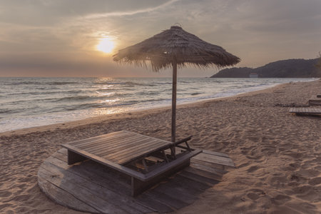 Sunset on the beach with sun loungers and umbrellasの写真素材
