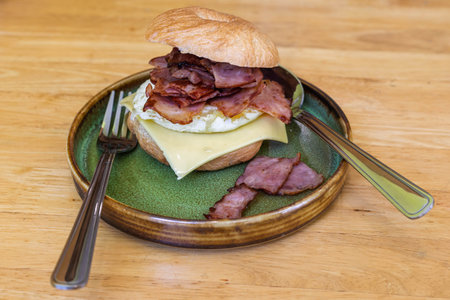 bagel with bacon and egg on a plate