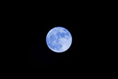 Bright and big blue full moonの写真素材