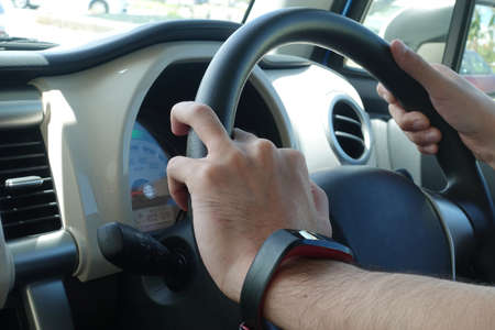 holding the steering wheel with both hands