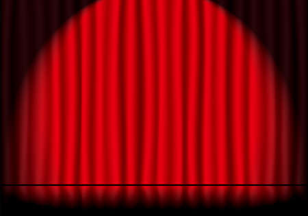 Spotlighted red stage curtains and reflective stage floorsの写真素材