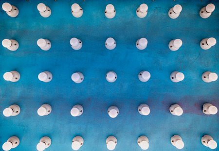 Abstract background with arranged light bulbs on blueの写真素材