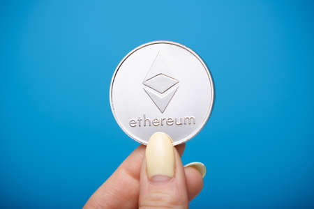 Ethereum coin in fingersの写真素材