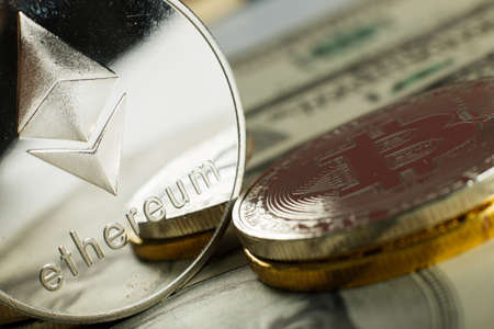 Ethereum coin with other cryptocurrency on dollar notes