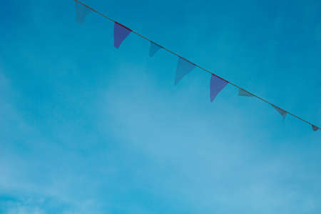 colorful flags in blue skyの写真素材