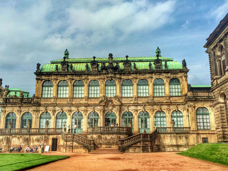 Beautiful historic building in the Zwinger Palace in Dresden with a blue cloudy skyのeditorial素材