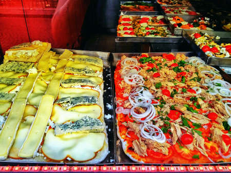 Plates with cheese pizzas and fishの素材