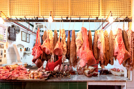 butchers stall with meat in an oriental bazar in the market hallの写真素材