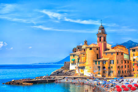 The old town of the seaport Camogli at the Italian Riviera with a gorgeous colored house facade and luminous shining blue skyのeditorial素材