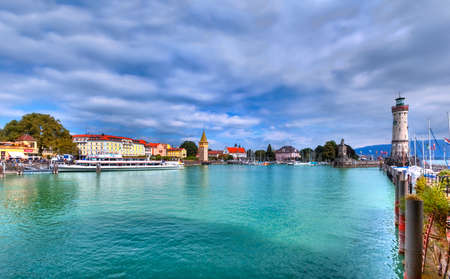 View to the harbor on the Iceland of Lindau at Lake Constance in the south of Germany with the the historical lighthouseのeditorial素材