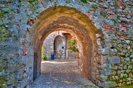 an archway in the charming village Malcesine at the east bank of the Lake Garda in Italyの写真素材