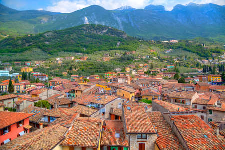 view over the red roofs of Malcesine at the east bank of the Lake Garda in Italyの写真素材