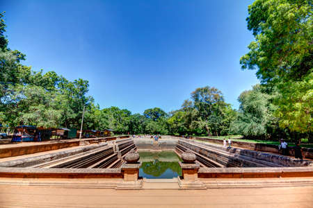 In the pilgrimage site of the old royal city Anuradhapura on the tropical Iceland Sri Lanka you find ruins of an old temple complex with baths, living and working places of buddhistic monks as well as ancient remains of gorgeous kings buildings and pagodaの写真素材
