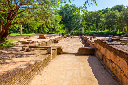 In the pilgrimage site of the old royal city Anuradhapura on the tropical Iceland Sri Lanka you find ruins of an old temple complex with baths, living and working places of buddhistic monks as well as ancient remains of gorgeous kings buildings and pagodaの写真素材