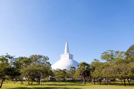 Stupa or pagodas are buddhistic buildings in the in the pilgrimage site of the old royal city Anuradhapura on the tropical island Sri Lankaの写真素材