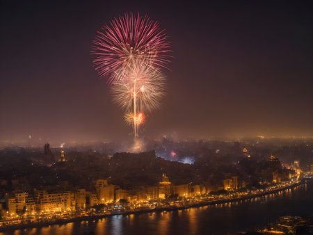 This image shows a fireworks display over the city of Cairo. The fireworks light up the night sky and are a stunning sight. The colors of the fireworks are varied and glow in a variety of waysの素材