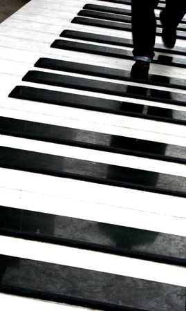 Man walking on giant piano keysの写真素材