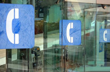 Three blue telephone box signs in a rowの写真素材