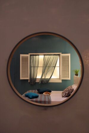 Lovely bedroom with cat sleeping on the bedの写真素材