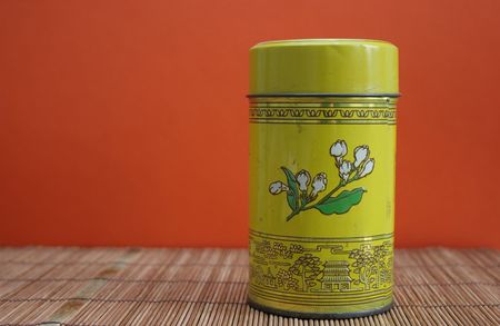 Old Chinese tea tin on bamboo - copy spaceの写真素材