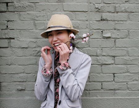 Korean woman with cherry blossom in her mouth