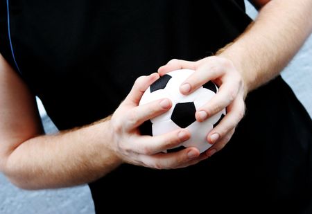 Close-up of a man holding a soccer ball