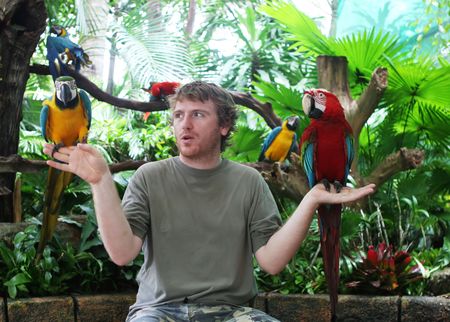 Man holding parrots
