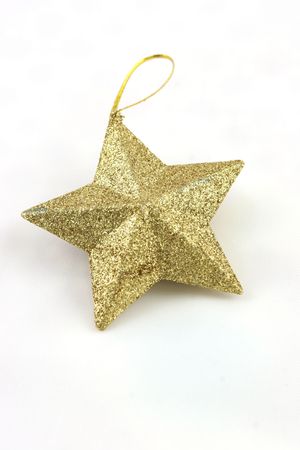 Gold star shaped Christmas decoration on a white background