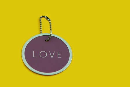 Purple love tag on a yellow backgroundの写真素材