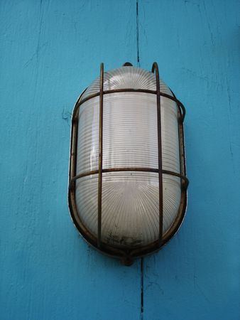 Light on a blue wood wallの写真素材